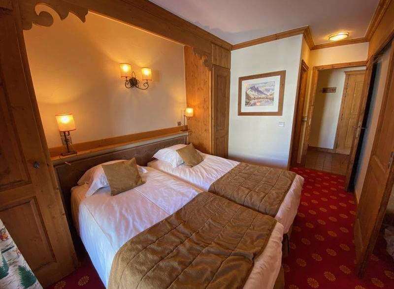 Cozy and inviting bedroom featuring two comfortable beds with soft bedding.