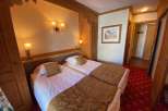 Cozy and inviting bedroom featuring two comfortable beds with soft bedding.