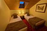 Cozy and inviting bedroom featuring two twin beds, perfect for a comfortable stay.