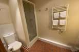 This bathroom features a modern shower with a glass enclosure, perfect for a refreshing start to your day.