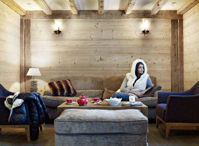 Cozy up in this charming living space, featuring rustic wooden accents and a warm, inviting atmosphere.