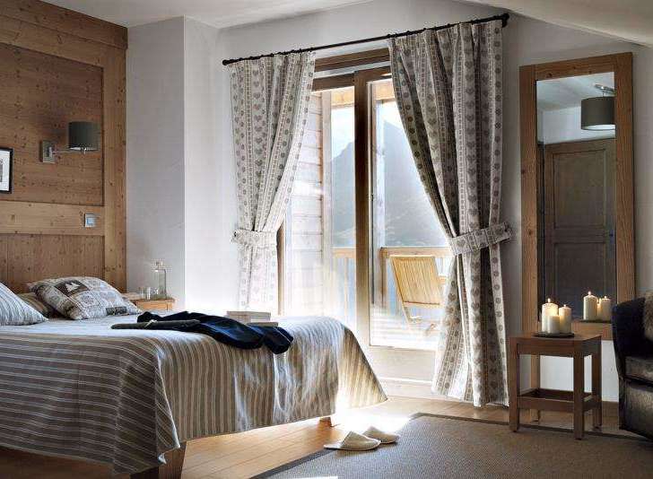 Cozy bedroom with wooden accents and a stunning view.