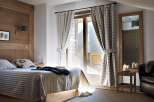Cozy bedroom with wooden accents and a stunning view.