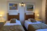 Cozy bedroom featuring two twin beds, perfect for a comfortable stay.