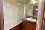 Discover a charming bathroom with a bathtub and shower combination, perfect for relaxation.