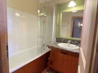 Discover a charming bathroom with a bathtub and shower combination, perfect for relaxation.