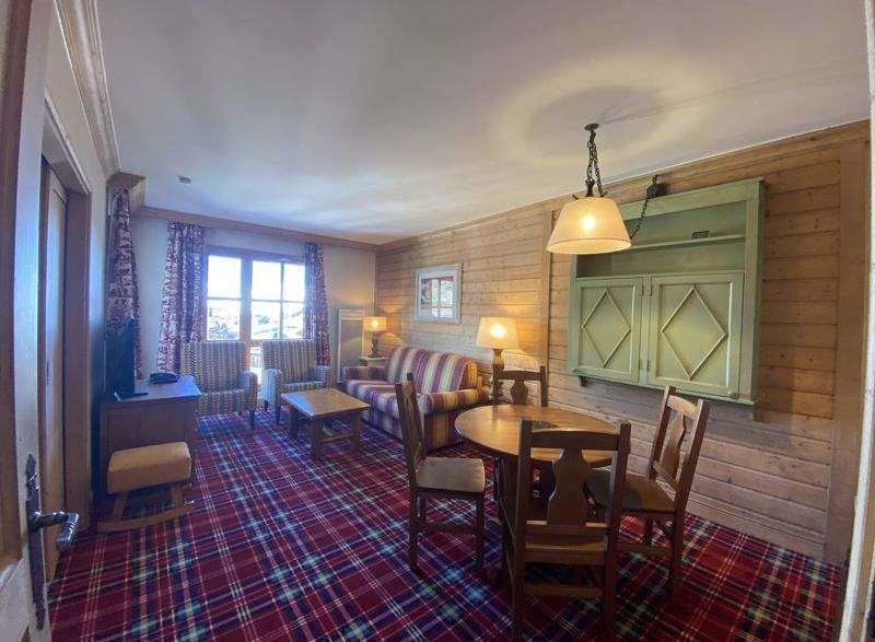 Cozy up in this charming living space, featuring a rustic wooden interior and a warm, inviting atmosphere.