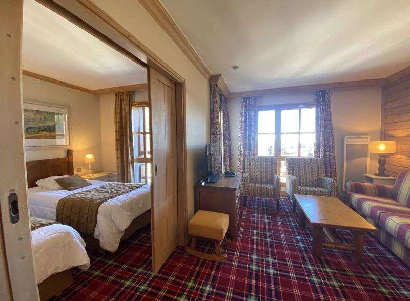 This cozy hotel room features a comfortable bed and a separate living area.
