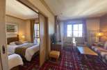 This cozy hotel room features a comfortable bed and a separate living area.