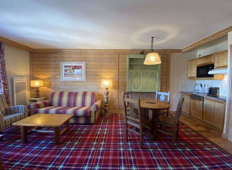 Cozy up in this charming living space, featuring a comfortable sofa and a warm, inviting atmosphere.
