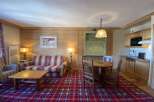 Cozy up in this charming living space, featuring a comfortable sofa and a warm, inviting atmosphere.