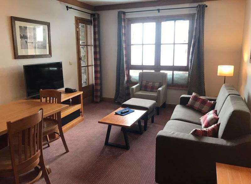 Cozy living space featuring a comfortable sofa and armchair, perfect for relaxation.
