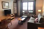 Cozy living space featuring a comfortable sofa and armchair, perfect for relaxation.
