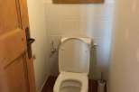 This charming property features a well-appointed bathroom with a modern toilet.