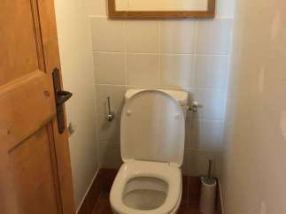 This charming property features a well-appointed bathroom with a modern toilet.