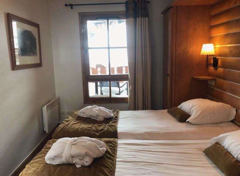 Cozy bedroom with twin beds, perfect for a relaxing stay.