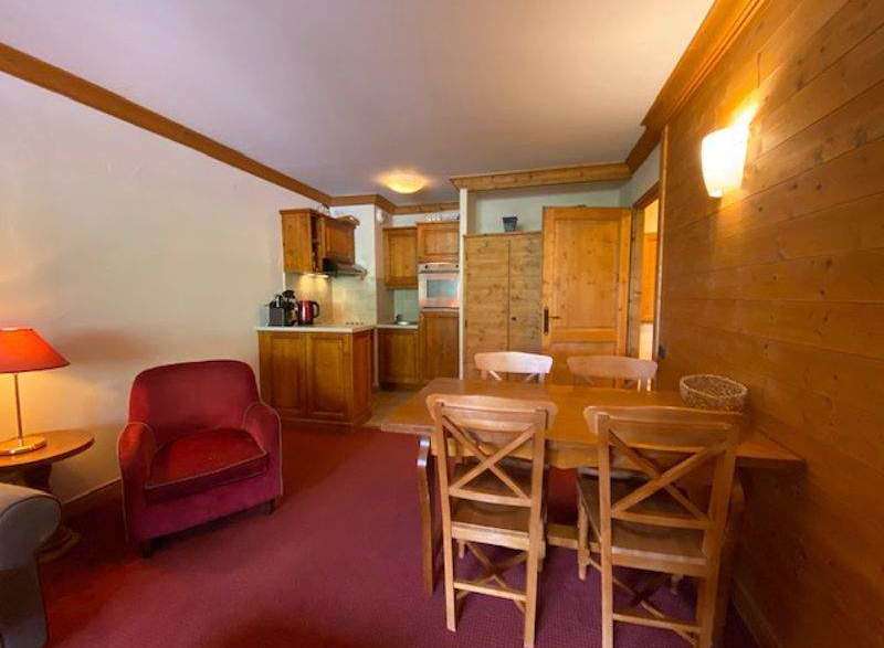 Cozy apartment with a rustic charm, featuring a warm wooden interior and a welcoming dining area.