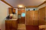 Cozy kitchen with wooden cabinets and a tiled floor.