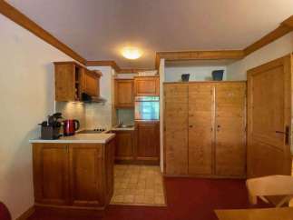 Cozy kitchen with wooden cabinets and a tiled floor.