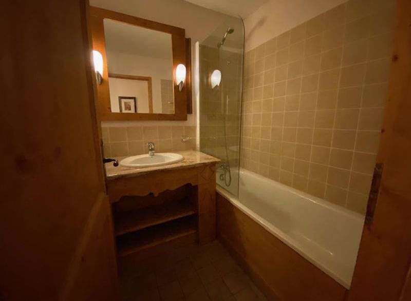 Discover a cozy bathroom with a charming wooden vanity and a classic bathtub.