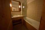Discover a cozy bathroom with a charming wooden vanity and a classic bathtub.