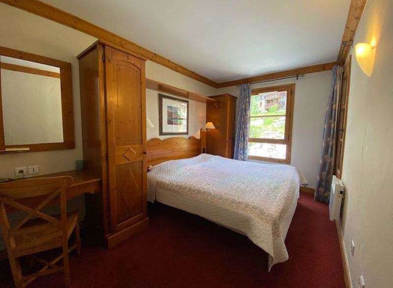Cozy bedroom featuring a comfortable bed with a patterned quilt, perfect for a relaxing stay.