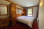 Cozy bedroom featuring a comfortable bed with a patterned quilt, perfect for a relaxing stay.