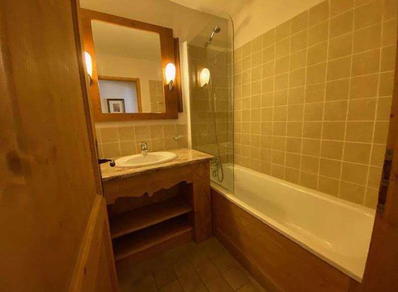 Discover a charming bathroom with a rustic wooden vanity and a sleek, modern sink.