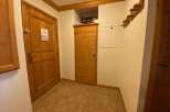 This charming property features a warm and inviting entryway with wooden doors and trim.