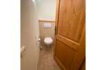 This charming bathroom features a clean white toilet and a convenient toilet paper holder.
