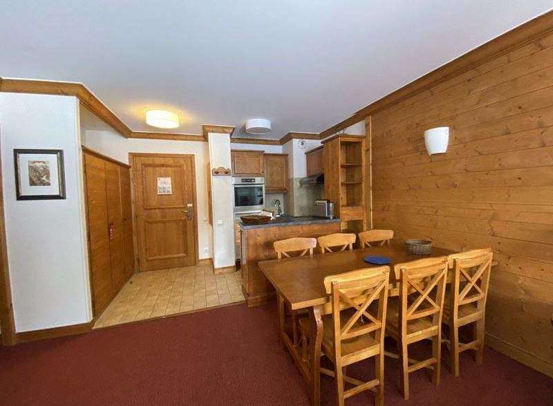 This charming property features a cozy dining area with a wooden table and chairs, perfect for enjoying meals.