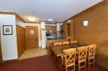 This charming property features a cozy dining area with a wooden table and chairs, perfect for enjoying meals.