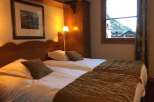 Cozy bedroom featuring two twin beds with comfortable bedding.