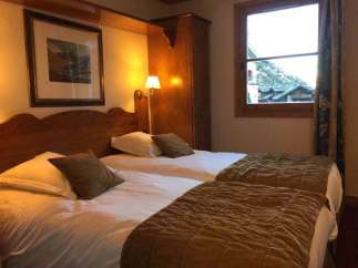 Cozy bedroom featuring two twin beds with comfortable bedding.