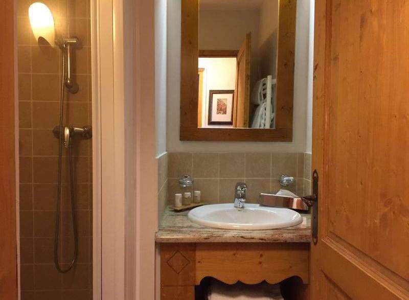 This charming bathroom features a classic design with wooden accents.