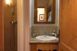 This charming bathroom features a classic design with wooden accents.