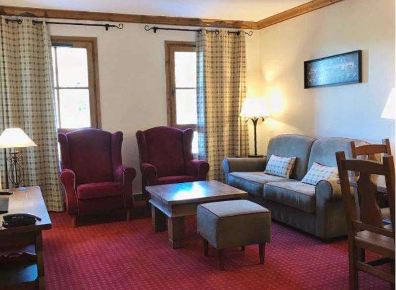 This cozy living space features comfortable seating, including armchairs and a sofa, perfect for relaxation.