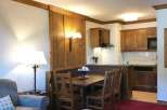 Cozy apartment with a rustic charm, featuring a dining area and a fully equipped kitchen.