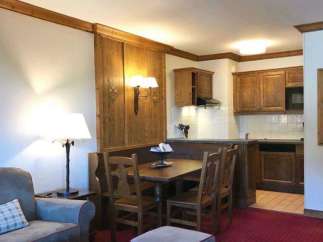Cozy apartment with a rustic charm, featuring a dining area and a fully equipped kitchen.