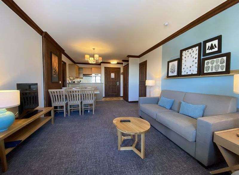 This cozy living space features a comfortable sofa with blue accent pillows, perfect for relaxing after a day of exploring.