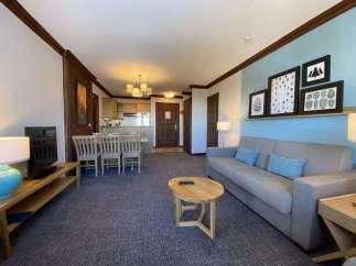 This cozy living space features a comfortable sofa with blue accent pillows, perfect for relaxing after a day of exploring.