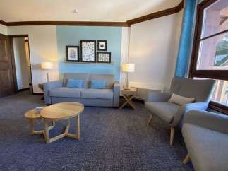 Cozy living room with a comfortable sofa and armchairs, perfect for relaxing.
