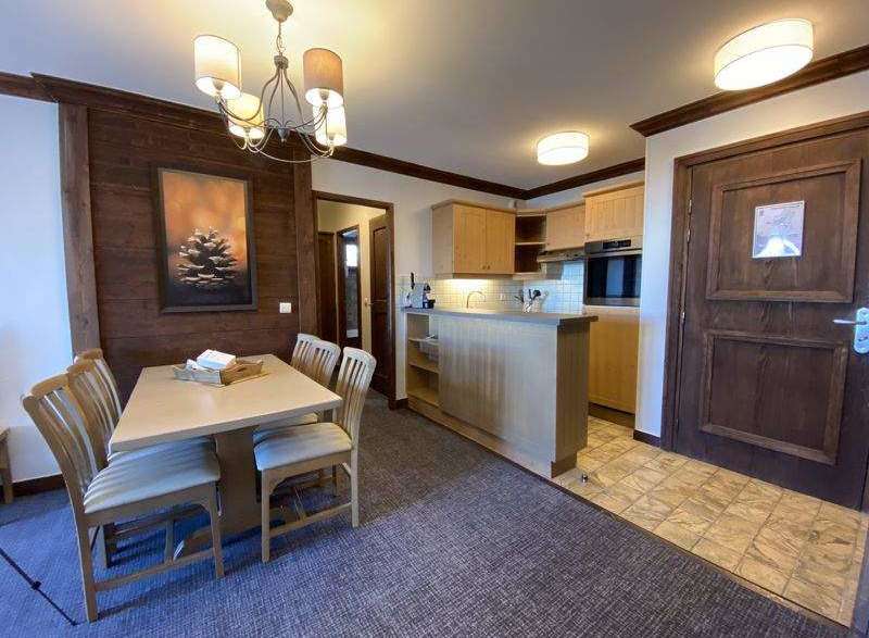This charming property features a cozy dining area with a stylish wooden table and chairs, perfect for enjoying meals.