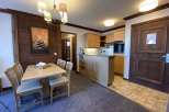 This charming property features a cozy dining area with a stylish wooden table and chairs, perfect for enjoying meals.