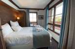Cozy bedroom with a comfortable bed and soft linens.