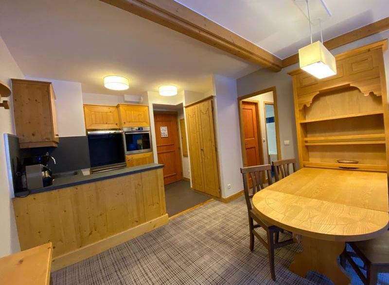 Discover a charming kitchen with wooden cabinets and a cozy dining area.