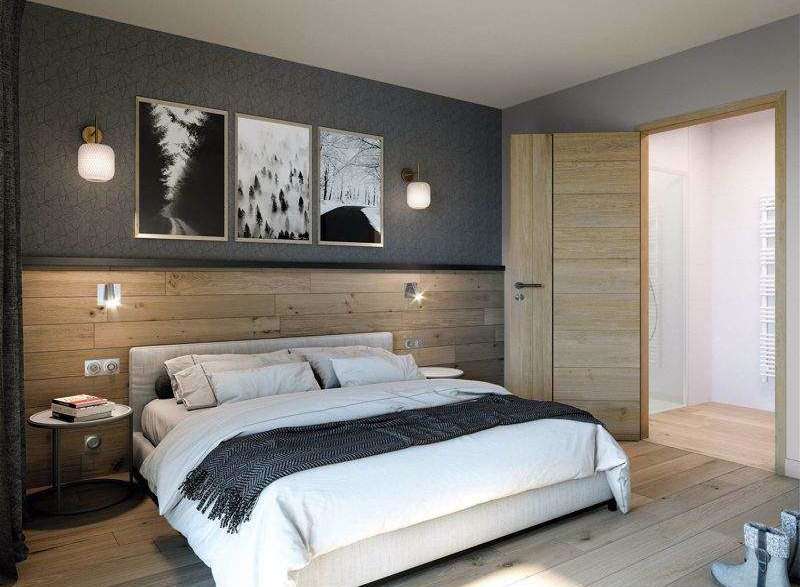 This cozy bedroom features a stylish blend of textures, with a wooden headboard and accent wall.