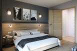 This cozy bedroom features a stylish blend of textures, with a wooden headboard and accent wall.