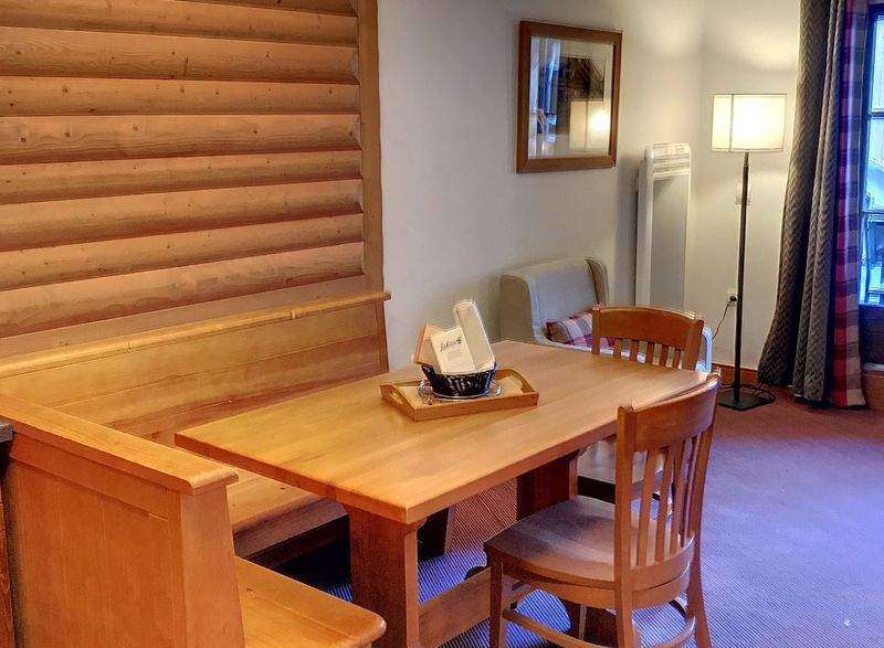 This charming property features a cozy dining area with a wooden table and chairs, perfect for enjoying meals.