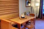 This charming property features a cozy dining area with a wooden table and chairs, perfect for enjoying meals.